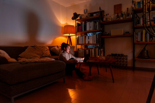 Focused woman working late on her tablet at home