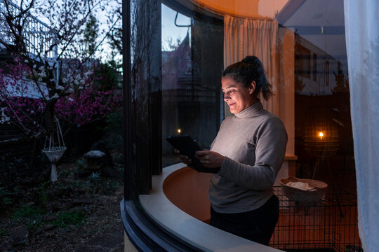 Woman using tablet at home in the evening