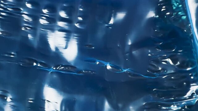 Abstract texture of crumpled blue plastic film