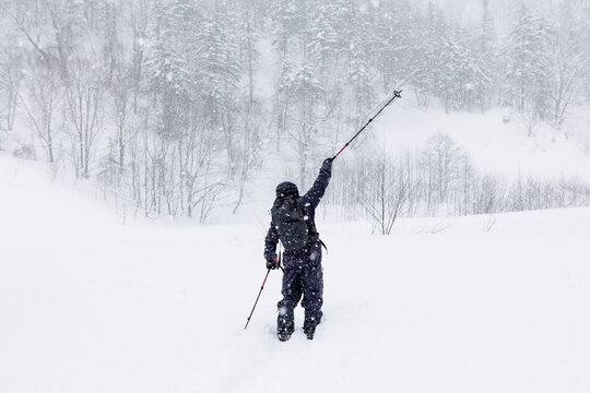 Man ski touring in deep powder during blizzard in Hokkaido