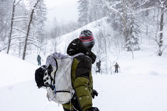 Ski tourer with backpack in Hokkaido powder snowfall