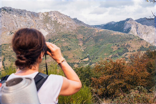 Female hiker viewing Somiedo mountain trail, Asturias