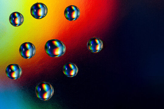 Vibrant neon drops on dark surface