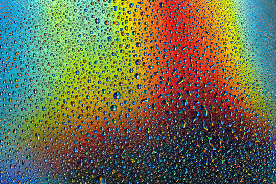 Colorful water droplets on a neon background