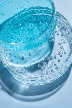 Macro laboratory glassware with blue gel and bubbles closeup