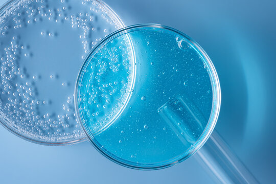 Laboratory glassware with blue gel and bubbles closeup