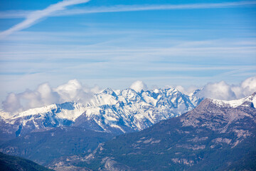 Fototapeta premium Mountain tops are covered with snow. Panorama of the mountains. Hautes-Alpes, Provence, France Provence Alpes Cote dAzur. 
