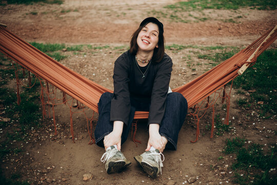 Woman relaxing in hammock outdoors during spring day