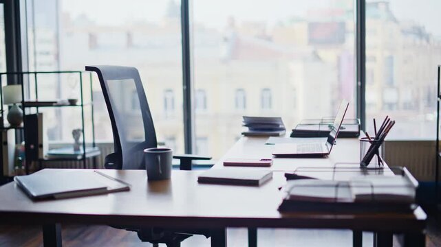 Empty modern office desk with laptop coffee cup notebooks stylish workspace