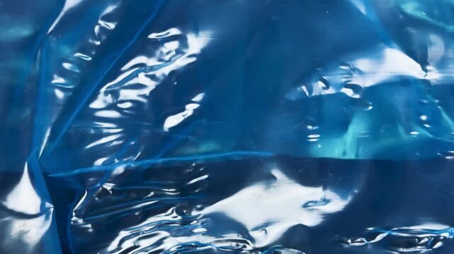 Wrinkled dark blue plastic film texture