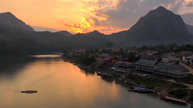 Beautiful Sunset in Nong Khiaw, a drone shot of picturesque Mountain Town on the Nam Ou River in Laos, Southeast Asia