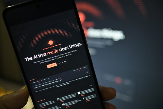 VEHARI, PAKISTAN - JULY, 27, 2026: Vibrant OpenClaw application logo glowing on a handheld smartphone display against a neon lit high-tech environment