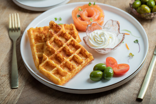 Crunchy waffle fries with sour cream dip served in a basket