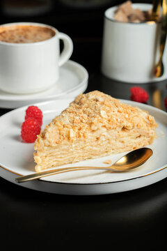 Sliced Napoleon cake on a white wooden table. Classic dessert