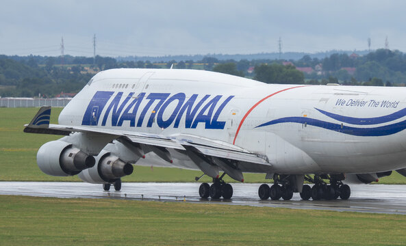 Prague, Czech Republic - July 27, 2026: National Airlines Boeing 747-400 BCF rolls along a wet runway in a close rear three-quarter view.