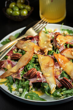 Salad with Pear, Arugula, Jamon, Blue Cheese and Blueberry, Delicious Fresh Salad Appetizer on Bright Background