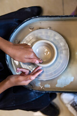 Fototapeta premium Young Artist Brings Imagination to Life in a Pottery Studio With Wet Clay