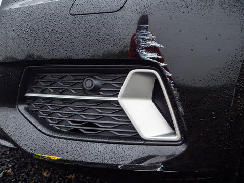 Black car with white scratch marks damage to its fine surface. Car accident or bad driving concept. Wear and tear. Cost and price of repair the damage. Waiting for insurance claim theme.