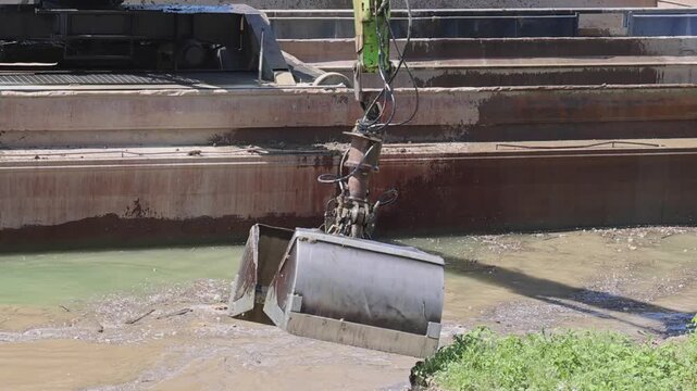 Rotary Clamshell Grab Bucket at Long Crane Excavator River Coast Cleaning Works