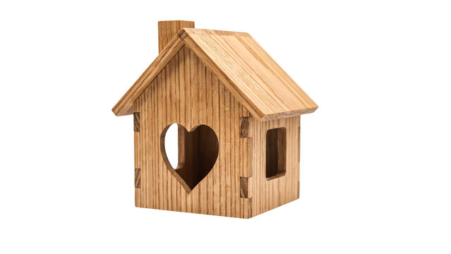 Wooden house model with heart shaped window cut out standing as a symbol for real estate on transparent background
