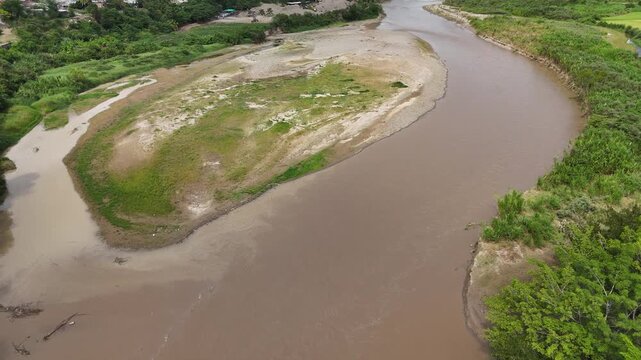 High angle aerial forward shot of wide river meander and gravel bar.