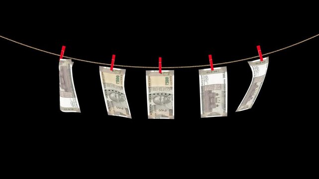 500 indian rupee banknotes hanging on a rope swaying in the wind