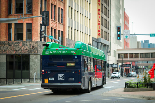 Duluth, MN, USA - Jul 25, 2026: Duluth Transit Authority DTA Go Line green and blue hybrid commuter bus traveling on a city street in downtown