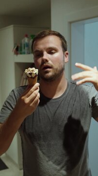 Sweaty man eating ice cream to cool down during heatwave