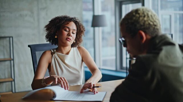 Business woman explaining contract terms in office meeting, client signing deal