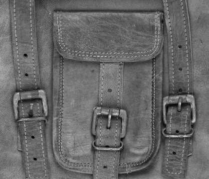 old leather pocket with leather straps