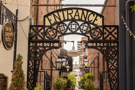 San Jose, California, USA - March 30, 2026: Decorative lights illuminate a wrought iron entrance in the San Pedro Square promenade walkway .
