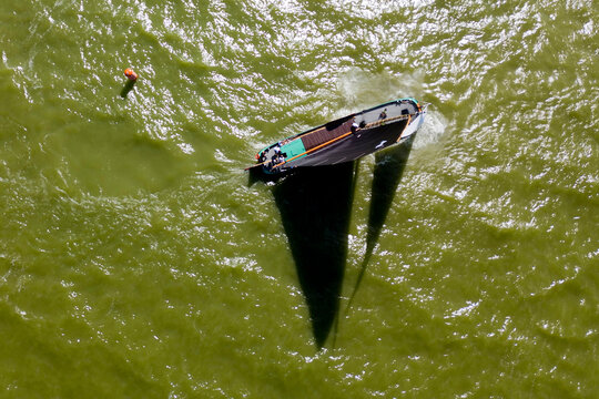 STAVOREN, THE NETHERLANDS AUGUST 12, 2023: Traditional Skutsjes Compete During the Annual SKS Skutsjesilen Sailing Championship on the IJsselmeer