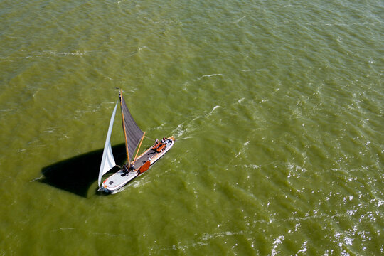 STAVOREN, THE NETHERLANDS AUGUST 12, 2023: Traditional Skutsjes Compete During the Annual SKS Skutsjesilen Sailing Championship on the IJsselmeer