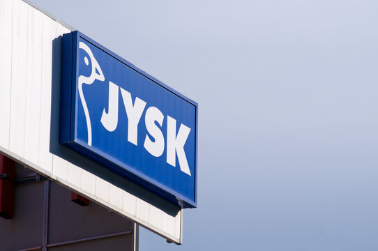 Jysk store logo sign with copy space against blue sky in Grancia, Switzerland