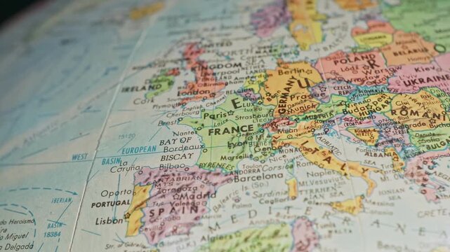Slow motion close-up view of Earth globe macro of European countries on continent of Europe showing cities, country landmarks, water ways, and important places across western global map texture 4k