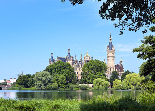 Schwerin castle, built in the historicist style on an island in the main lake of the capital city from Mecklenburg-Vorpommern, Germany, copy space in the blue sky