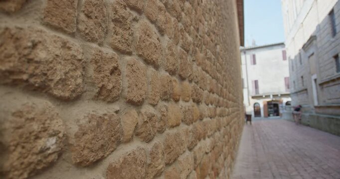 Medieval tuff stone wall in a tuscan village street