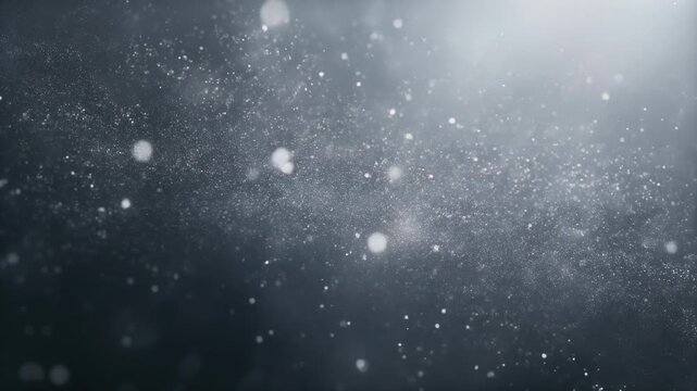 Abstract particles or dust illuminated in a dark, blurred background