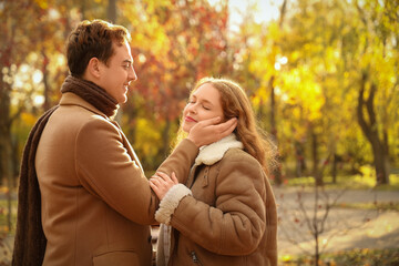 Fototapeta premium Beautiful loving young happy couple in autumn park