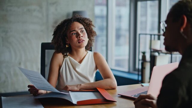 Business woman analyzing document skeptical then smiling office meeting closeup
