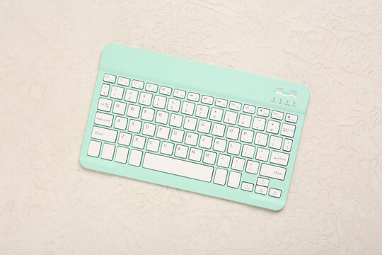Stylish cyan keyboard on white background