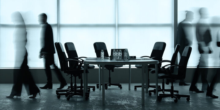 Blurred motion of business people walking past a modern conference room with an empty table and chairs, Sense of dynamic activity and the constant movement within a corporate environment