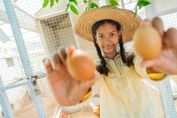 ํYoung woman collecting fresh eggs in chicken coop. Teenager girl with organic farming and free range poultry, sustainable agriculture, rural farm lifestyle and healthy food production. © CandyRetriever 