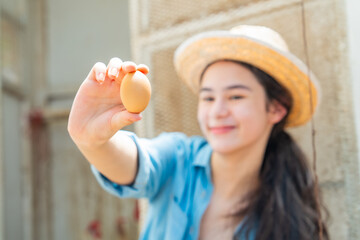 ํYoung woman collecting fresh eggs in chicken coop. Teenager girl with organic farming and free range poultry, sustainable agriculture, rural farm lifestyle and healthy food production. © CandyRetriever 
