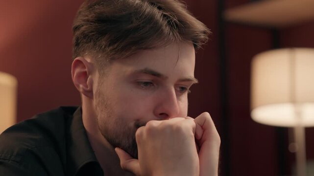 Nervous confused drunk Caucasian man gambler try focusing poker game casino home uncertain addict male gamer player trying concentrate think holding head gambling addiction guy drinking smoking indoor