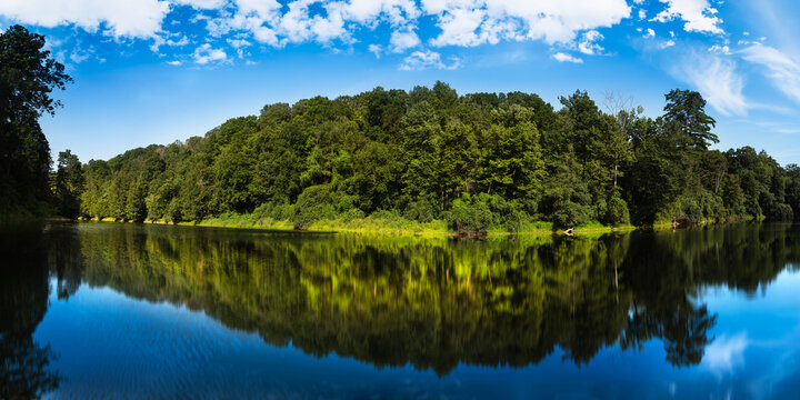 Middlebury Hiking Series: Otter Creek panorama with forest and water reflection along TAM, Trail Around Middlebury, in Vermont, USA