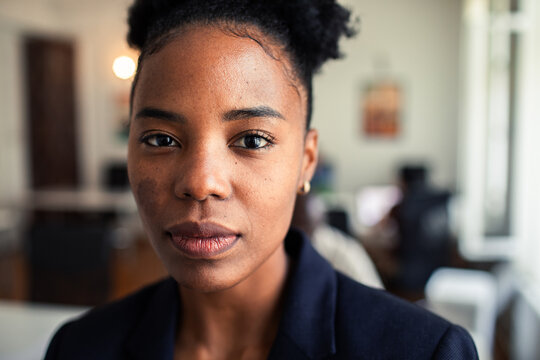 Confident young professional woman portrait in office