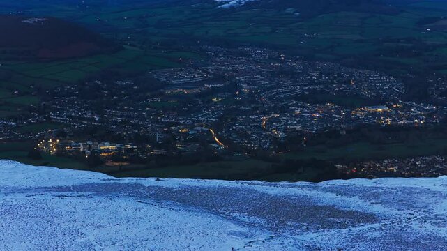 4K Aerial View of Abergavenny in the distance ontop of mountain Known as Blorenge South Wales UK Drone footage Snow on mountains