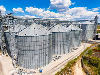 Grain storage facility with silos and a clear blue sky in daytime © DSMT