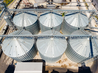 View of metal silos at a commercial storage facility in an industrial area during midday © DSMT